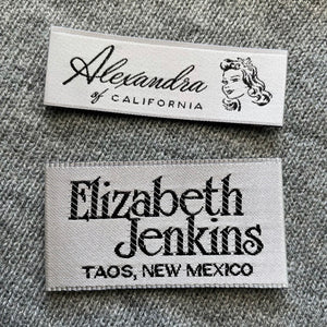 Satin woven labels with white base and black thread