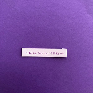 Satin woven label with white base